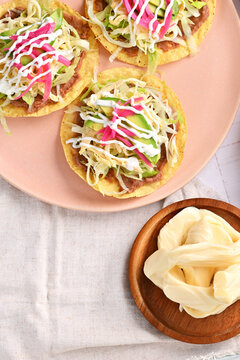 Chicken tostadas. Delicious homemade Mexican food with quesillo cheese on a plate top view