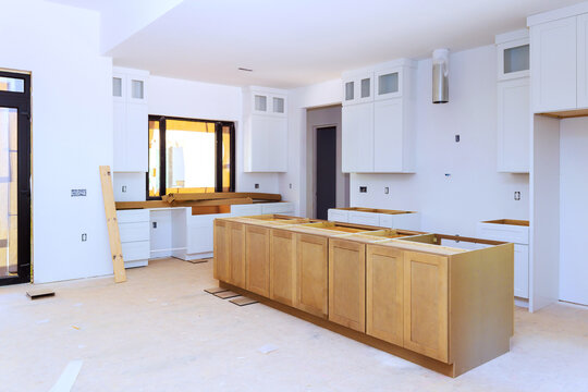 Kitchen under construction with cabinets countertops being installed in new home