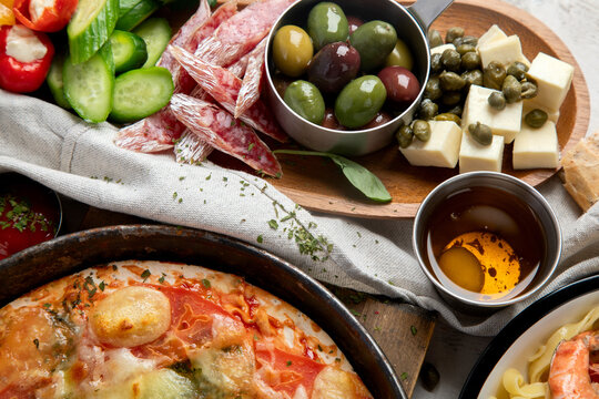 Italian cuisine. Pasta, pizza, olives and antipasto toasts.