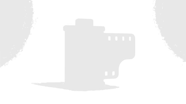Classic 35mm photographic film roll canister on dark background.