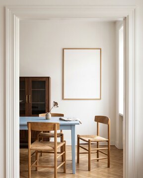 Blank wood frame mockup in charming dining nook with pastel blue table viewed through doorway