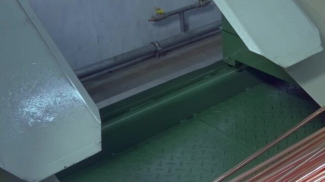 This close-up showcases intricate process of industrial machine shaping copper tube parts for air conditioners. Slow motion highlights every detail of this fascinating manufacturing technique.