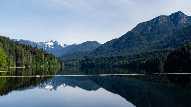 Capilano reservoir lake with reflection and mountains North Vancouver British Columbia Canada