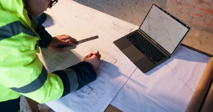 Blueprint, laptop and construction worker on site with design for building, repairs or renovation. Tech, man and civil engineer with floor plan and computer for maintenance or property development.