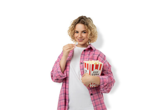 Woman holds popcorn while smiling happily at the cinema, PNG