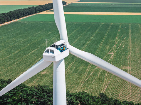 Worker performing routine inspection inside wind turbine nacelle