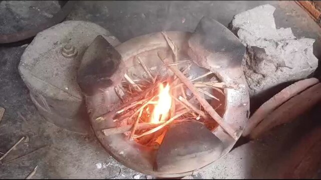 Hands Lighting Traditional Wood Burning Stove for Cooking in Vietnam