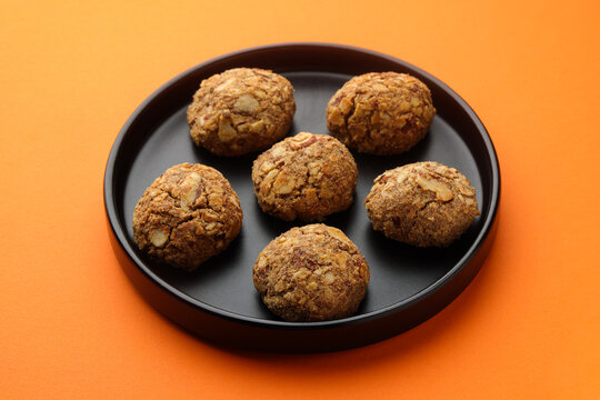 Indian cookies called ragi badam cookies isolated on orange background 