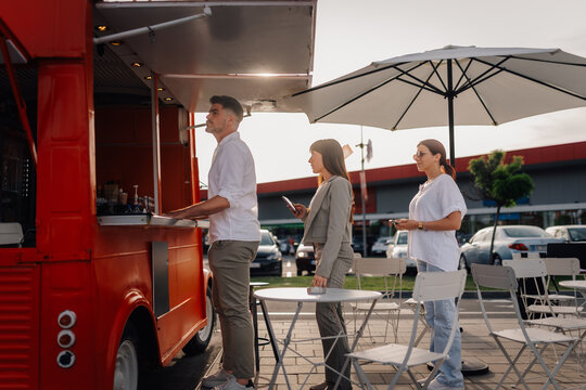 People queuing at a food truck for street food