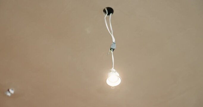 Ceiling, cable and open outlet with light for electrical work, unfinished installation or wiring. Empty, hole or electric repair with power or bulb for maintenance or building fitting below on space