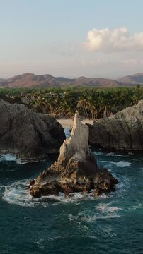 Dedo de Dios (Finger of God) Rock Formation In Playa Maruata, Michoacan, Mexico - Vertical, Drone Shot
