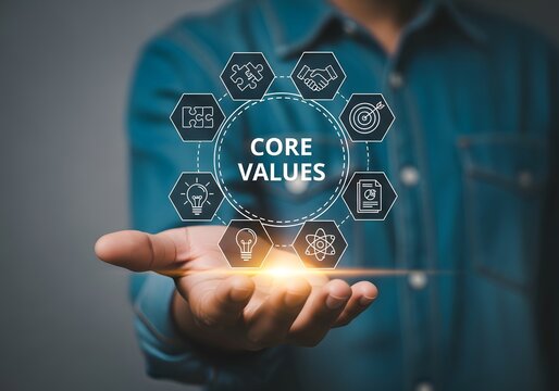 Professional hand holding a glowing core values icon with interconnected business principles like integrity, teamwork, and innovation on a digital interface