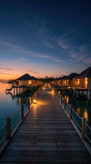 Obraz premium Serene overwater bungalows at sunset with wooden pier and calm water