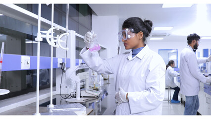 female brown scientist using chemicals in a laboratory. diversity in science laboratory with hplc, spectrometer, gc, uv, ir. hi tech latest machine equipments in Science experiment lab research  © Paul Reverve