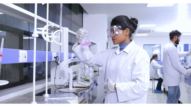 female brown scientist using chemicals in a laboratory. diversity in science laboratory with hplc, spectrometer, gc, uv, ir. hi tech latest machine equipments in Science experiment lab research 