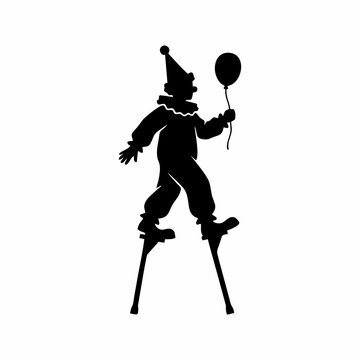 Silhouette of a clown walking on stilts holding a balloon isolated on white background