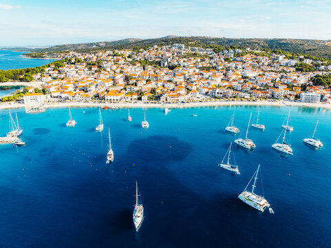 Aerial view of the historic town of Primosten on a peninsula, surrounded by crystal clear turquoise Adriatic sea, Dalmatia, Croatia.