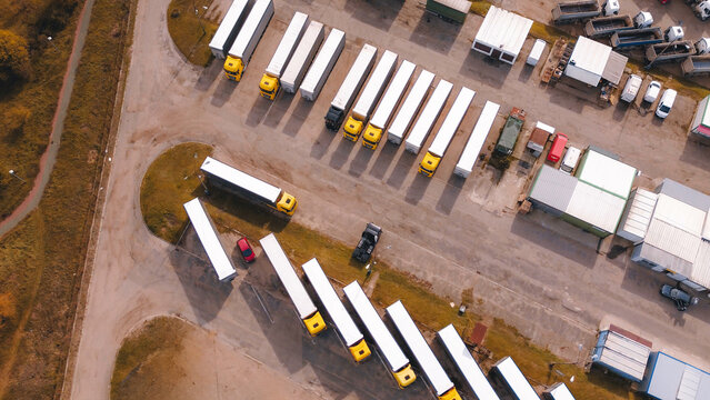 Trucks and trailers parked at depot
Aerial view of logistics warehouse yard