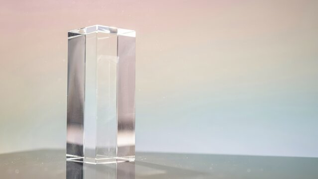 Clear rectangular prism on reflective surface glass