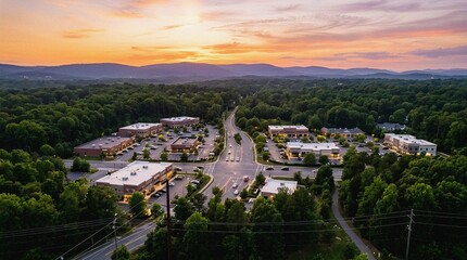Obraz premium Aerial Sunset View Modern Business Park Amidst Lush Forest Mountains