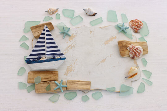 summer background with blue sea glass and shells