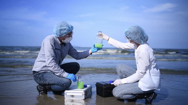 Scientist annalist wearing protective uniform, mask ,glove and under working water analysis effected from phytoplankton at sea analyst case in laboratory is environment pollution problem concept.