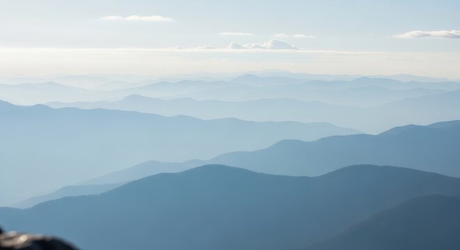 Distant Hazy Mountain Ranges Under a Soft Sky