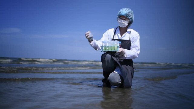 Scientist annalist wearing protective uniform, mask ,glove and under working water analysis effected from phytoplankton at sea analyst case in laboratory is environment pollution problem concept.