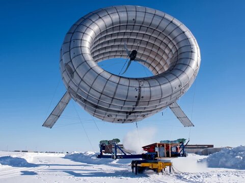 Toroidal airborne turbine hovers low over a snowy field, blades visible through its open core.