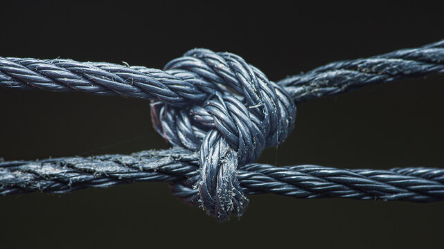 Strong black rope knot forming connection concept