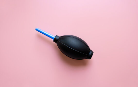 Air blower for the camera on a pink background. Top view, space for text.