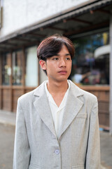 Obraz premium Portrait of non-binary Thai Isan professional looking away outdoors