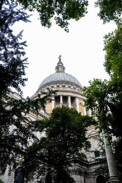 St Paul's Cathedral dome framed by green trees in London
