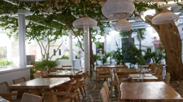 Mykonos terrace cafe scene with soft bokeh blurred background outdoor; background backplate copyspace calm.