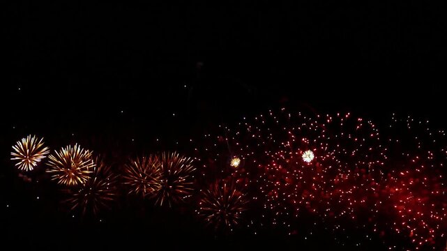 Grand display of colorful fireworks exploding in dark night sky during celebration event.