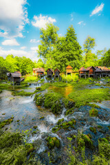 Obraz premium Historic wooden watermills (Mlincici) on the travertine barriers of Plivsko Lake near Jajce, Bosnia and Herzegovina.