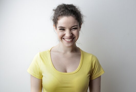 Young woman gives a big scrunchy smile