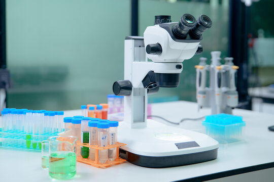 Laboratory Microscope and Test Tubes for Scientific Research and