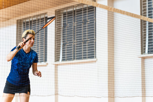 Focused female badminton player ready for a shot