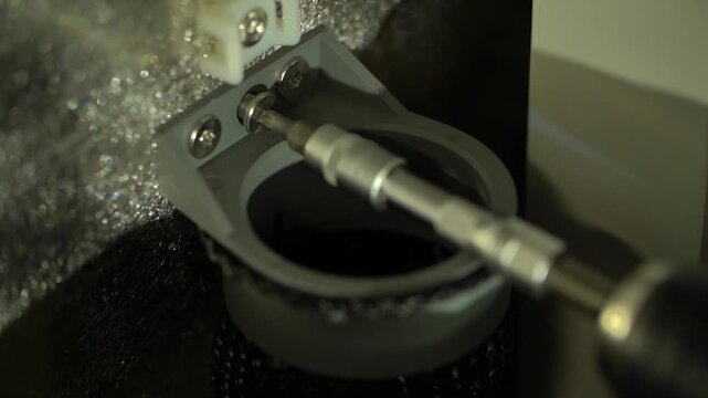 Screwing part to metal object at workshop of assembly plant during production.