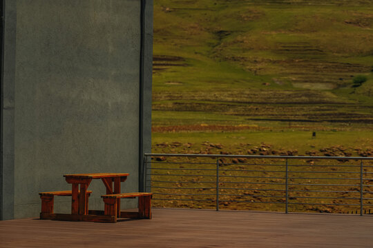 View of a wooden picnic table on a deck overlooking rolling green hills and terraced fields in Maseru, Lesotho.