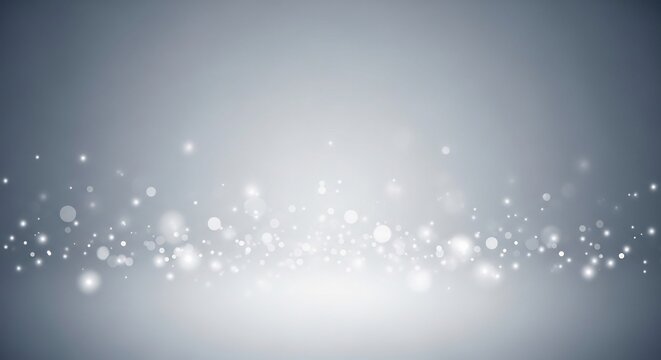 Sparkling white particles on a gradient gray background with bokeh effect