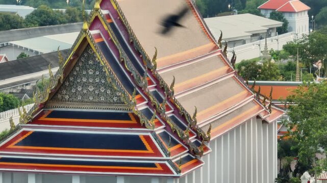 The ornate roofs of The Grand Palace in Bangkok, Thailand, showcase traditional Thai architecture with vibrant colors and intricate details, a significant cultural landmark.