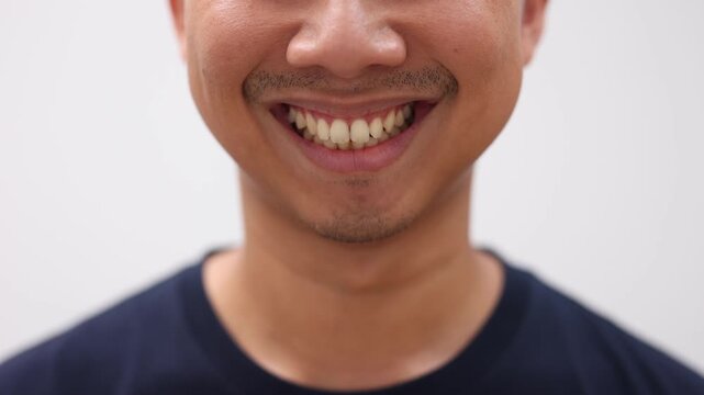 Close up face of asian man smile slow motion 