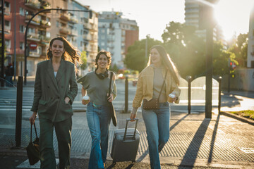 Three young women walking on city street at sunset © Miljan Živković