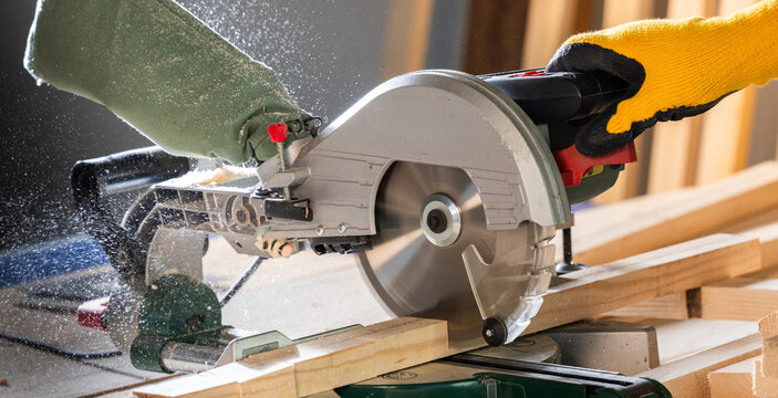 Power miter saw on a cut wooden trim base molding