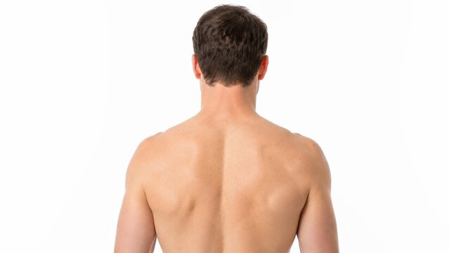 A shirtless man standing in a bright home applies a rectangular medicated back patch onto his upper back to relieve muscle pain and tension