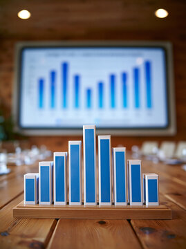 A minimalist scene of a boardroom with a presentation screen displaying a comparative analysis of hedge funds and traditional investments, leaving ample copy space.