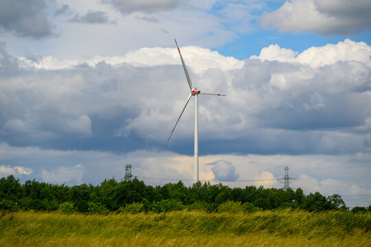 Wind Turbine in a shown clearly in the frame in an outdoor setting, in a natural environment, under daylight, with a energetic mood, suitable for travel, outdoor, and lifestyle campaigns.