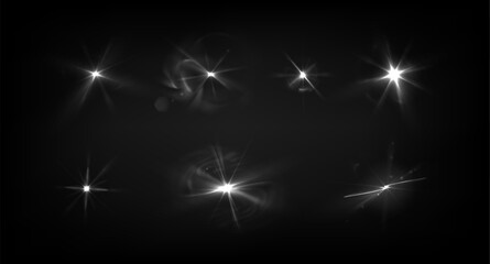 Fototapeta premium Glowing light flash set with smoke effect isolated on black background. Vector realistic illustration of neon white star shine with radiant beams, bright shimmering starburst with luminous flare